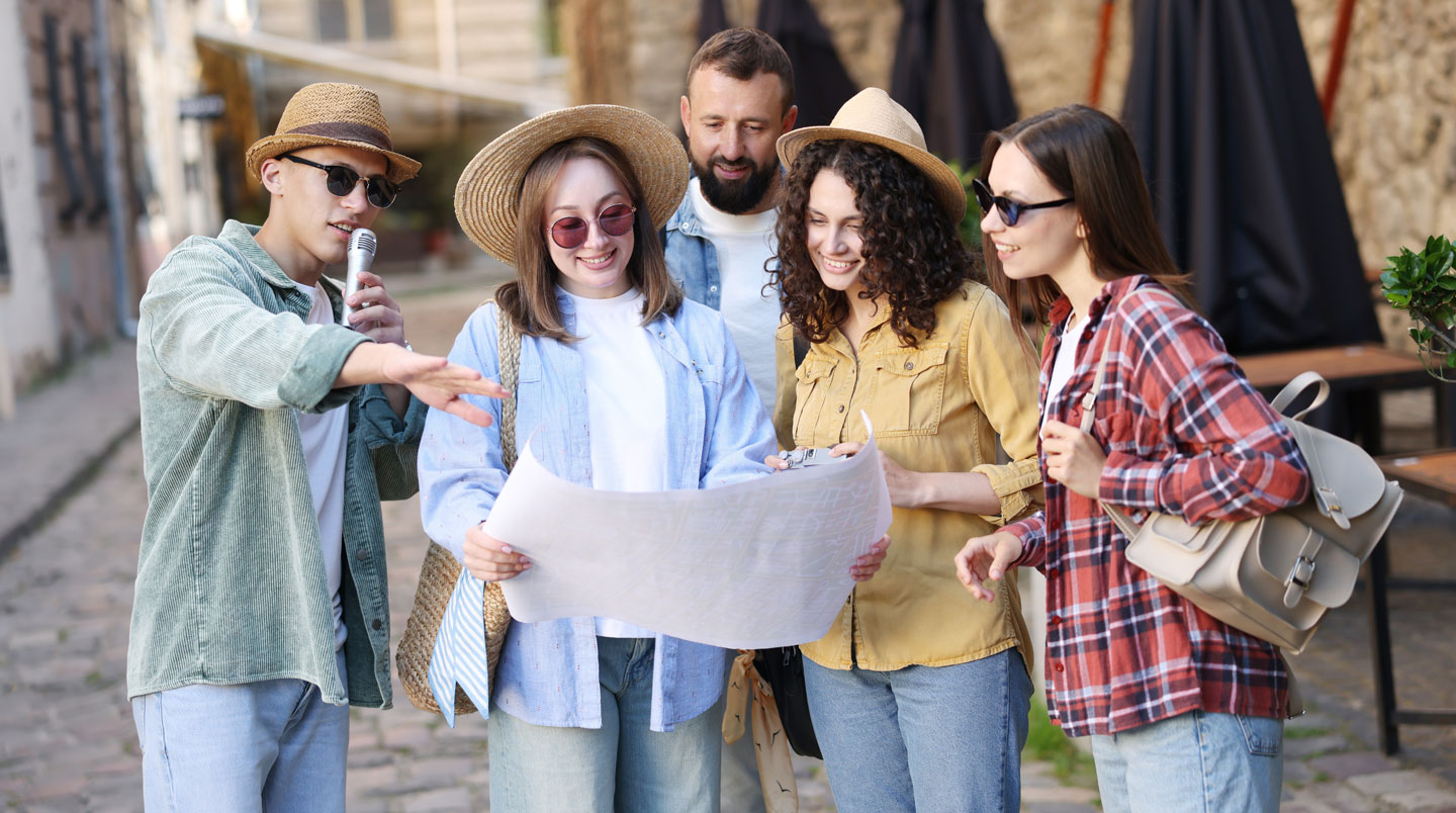 Animateur professionnel français coordonnant avec dynamisme une activité de team building en extérieur, donnant des instructions à un groupe de participants engagés dans l'activité